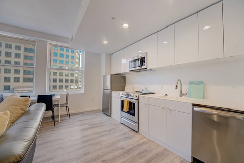 A modern kitchen with a stainless steel dishwasher and a white oven.