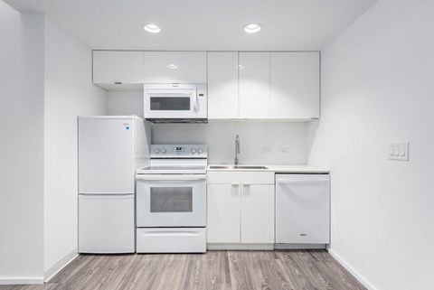 Kitchen With White Cabinetry And Appliances at Market District Lofts, Cleveland, OH