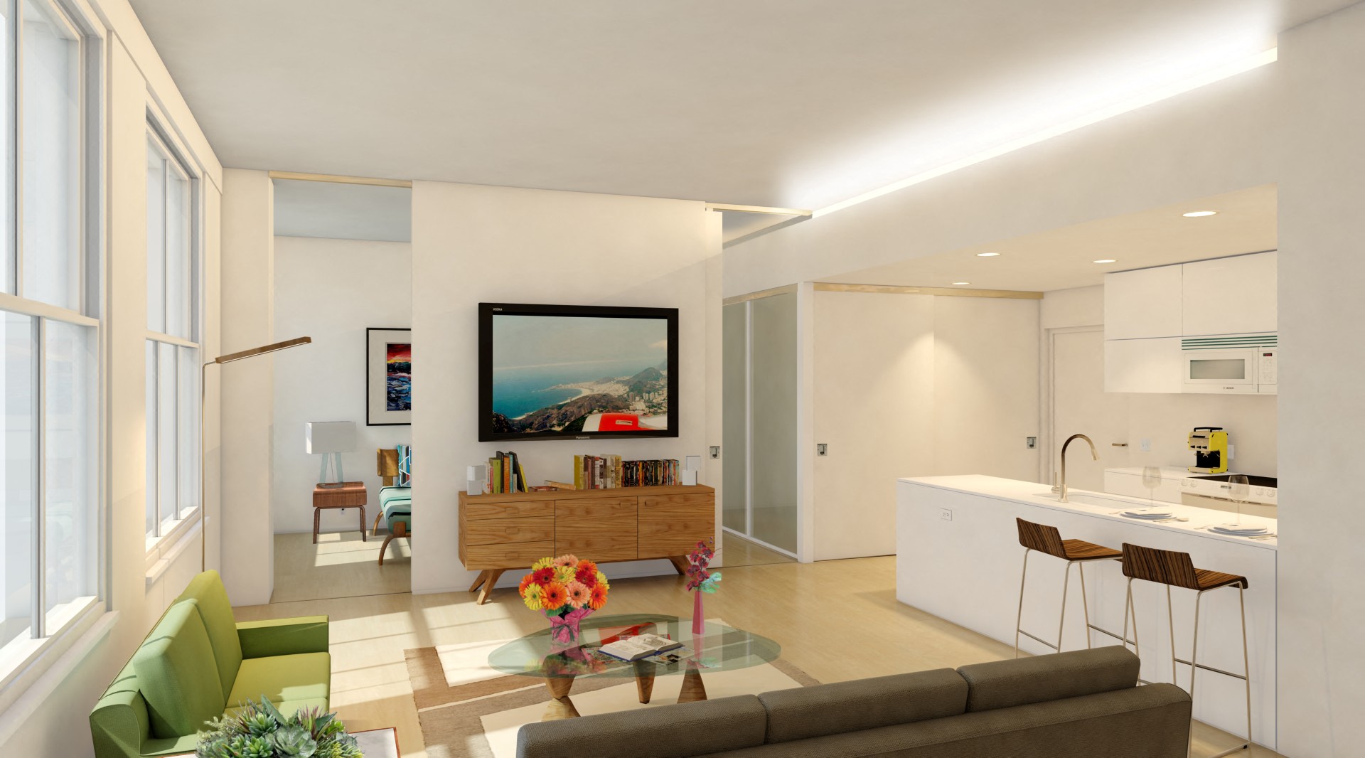 a living room with a couch and a table in front of a kitchen