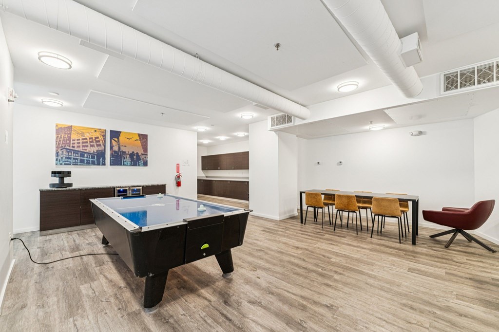 A room with a pool table and a ping pong table.