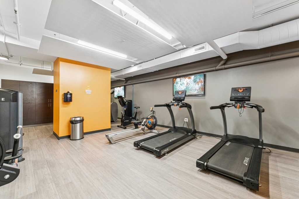 A gym with treadmills and other exercise equipment.