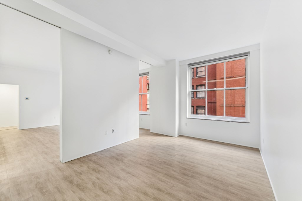 A room with a window and a door.