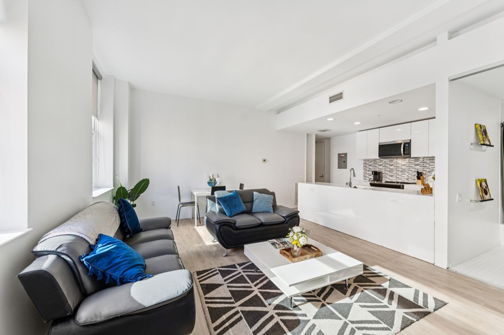 A modern living room with a grey sofa and a coffee table.