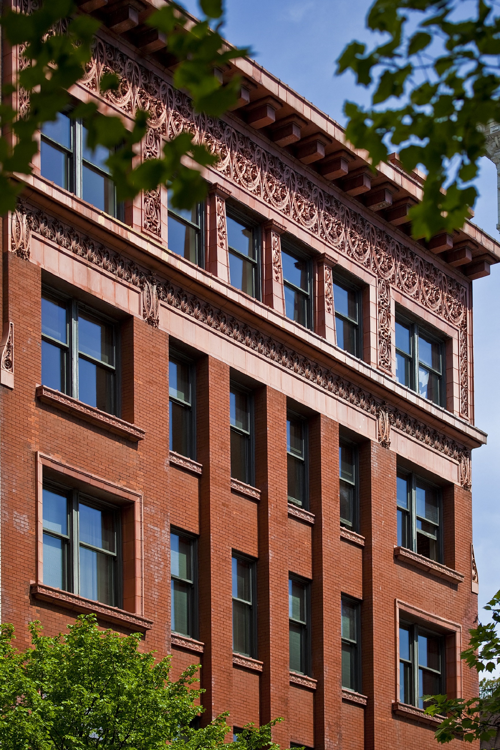 a red brick building with windows and trees