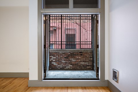 a view of a brick building through an open door