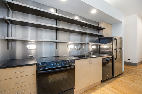a kitchen with stainless steel appliances and wooden cabinets