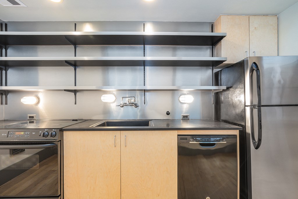 a kitchen with stainless steel appliances and wooden cabinets
