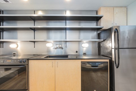 a kitchen with stainless steel appliances and wooden cabinets
