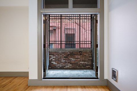 a view of a brick building through an open door