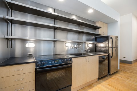 a kitchen with stainless steel appliances and wooden cabinets