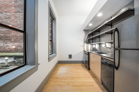 a kitchen with stainless steel appliances and a large window