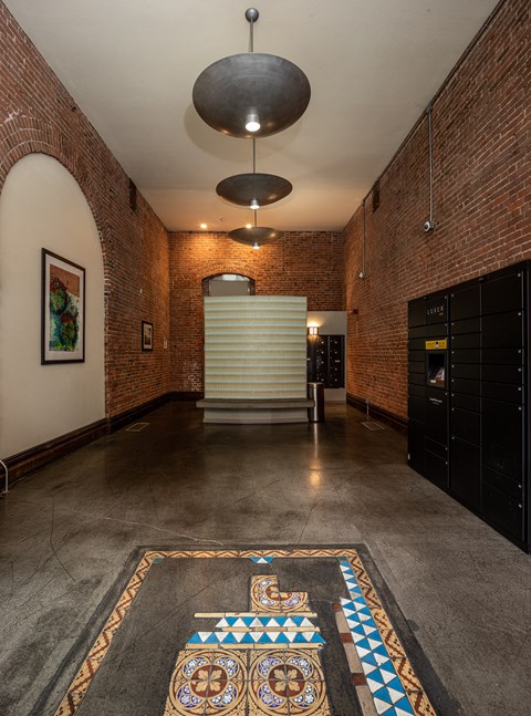 a large room with brick walls and a large rug on the floor