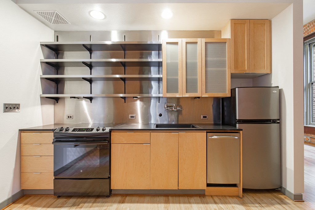 a kitchen with stainless steel appliances and wooden cabinets