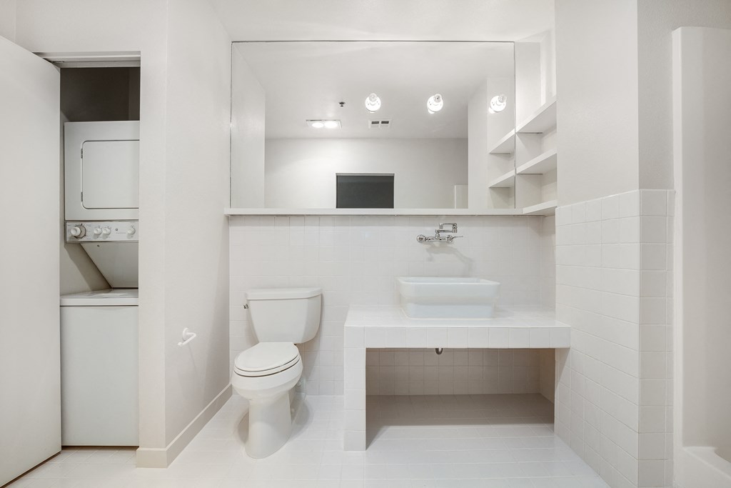 a bathroom with a toilet sink and a mirror