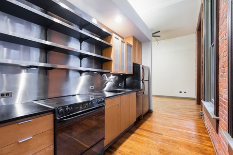A modern kitchen with wooden cabinets and stainless steel appliances.
