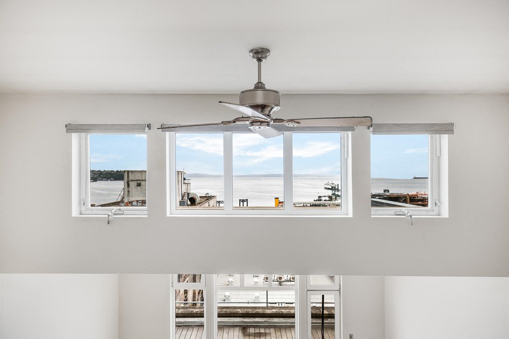 a view of the harbor from a window with a ceiling fan