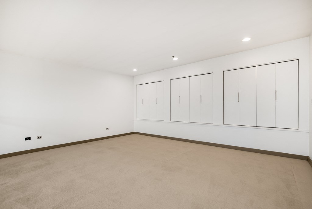 a large room with white walls and white cabinets