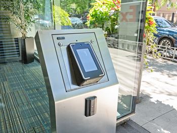 an iphone on a parking meter on a city street at One 333, Chicago, Illinois, 60605