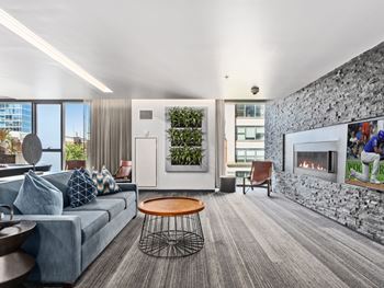 a living room with a gray couch and a fireplace at One 333, Chicago, Illinois, 60605