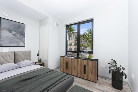 a bedroom with a bed and a large window