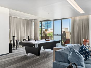 a living room with a pool table and a blue couch at One 333, Chicago, Illinois