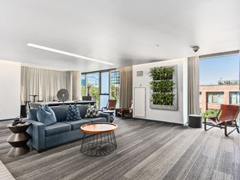 a living room with a blue couch and a coffee table at One 333, Illinois, 60605