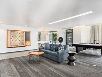 a living room with a couch and a pool table at One 333, Chicago, IL