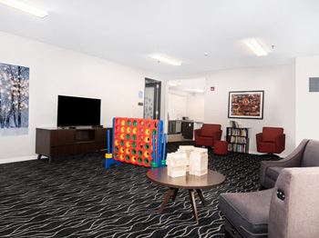 a living room filled with furniture and a flat screen tv