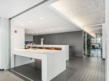 an open office area with a white counter and a glass door at One 333, Chicago, 60605