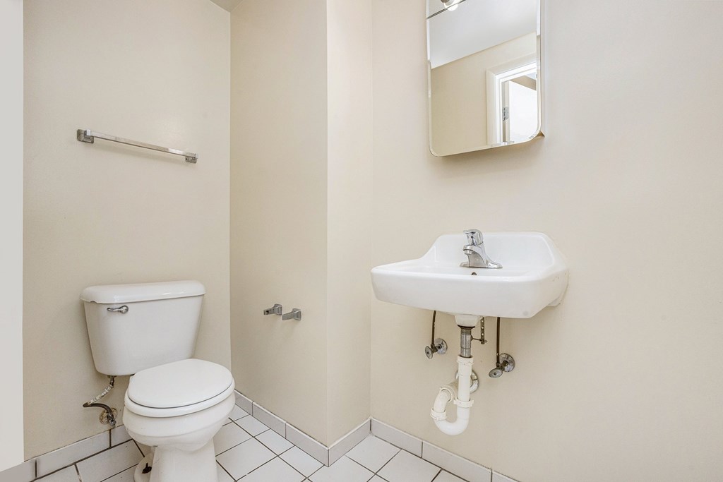 A white toilet and sink in a bathroom.