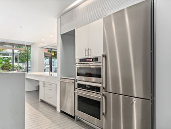 a kitchen with stainless steel appliances and white cabinets at One 333, Chicago, Illinois