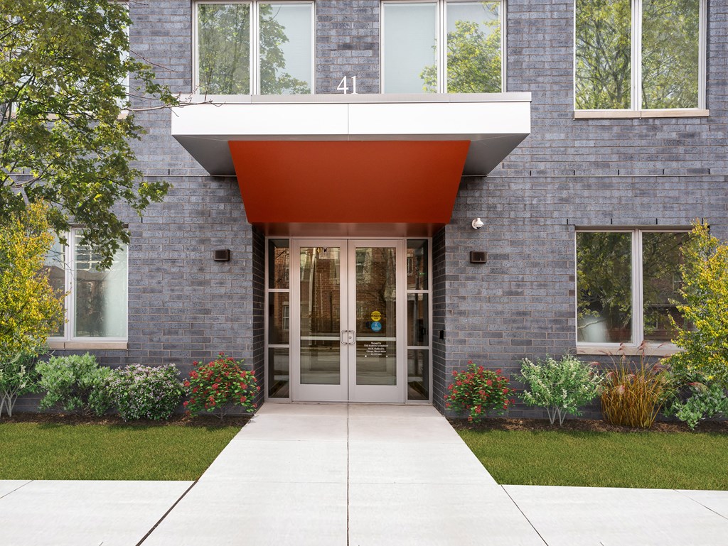 the entrance to a building with a red awning over the door