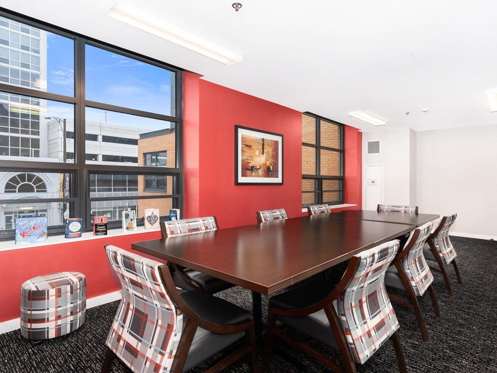 a conference room with a table and chairs and a large window