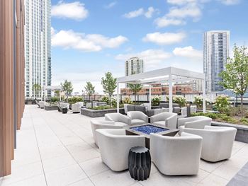 a rendering of a rooftop patio with couches and afire pit  at Cassidy on Canal, Chicago