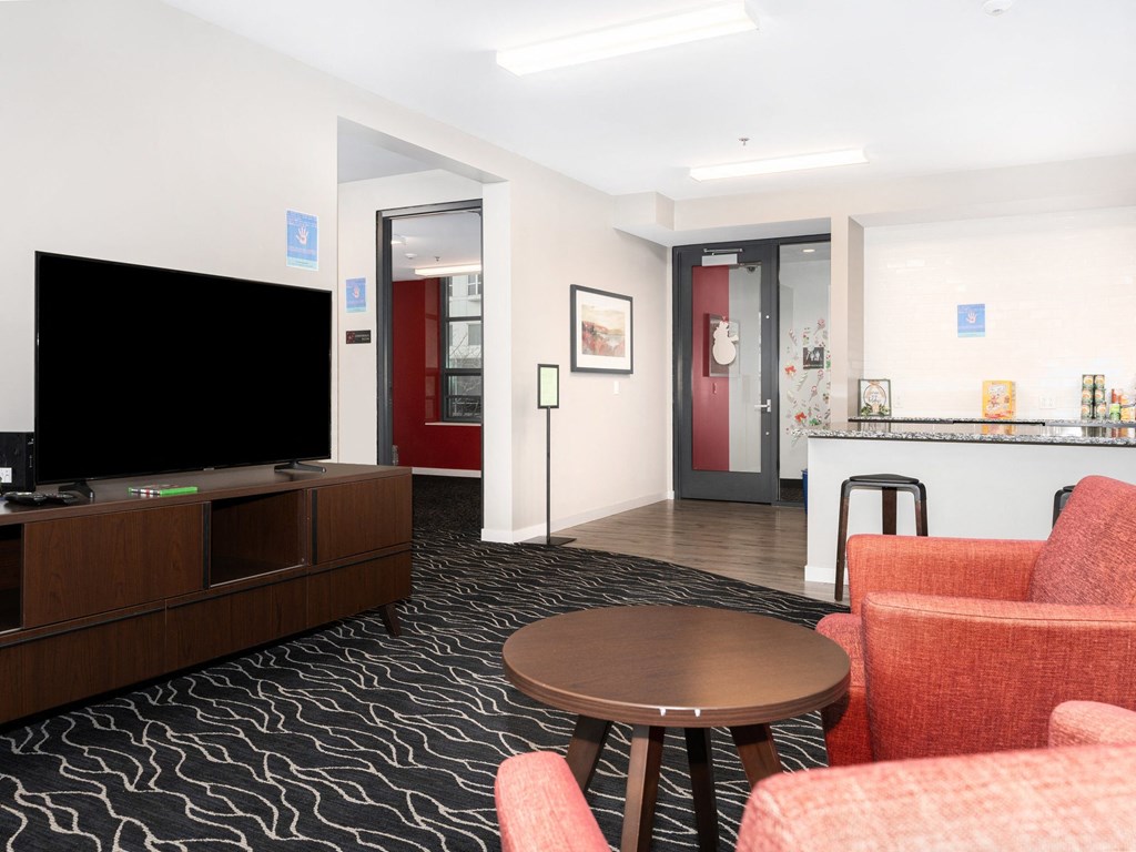 a living room with a television and a table and chairs