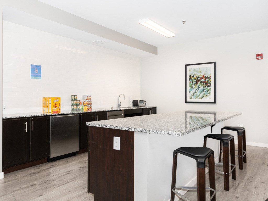 a kitchen with a counter top and three stools