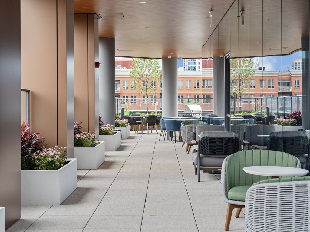 a large patio with tables and chairs and large glass walls  at Cassidy on Canal, Chicago, Illinois