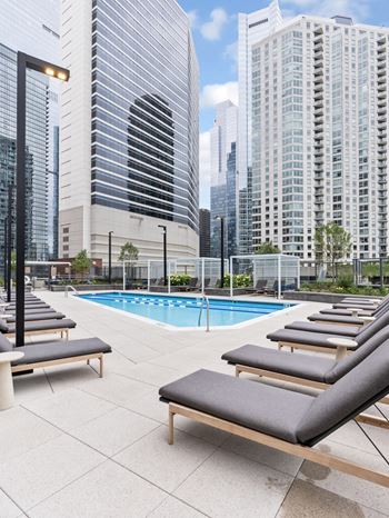a pool on the rooftop of a building with skyscrapers  at Cassidy on Canal, Chicago
