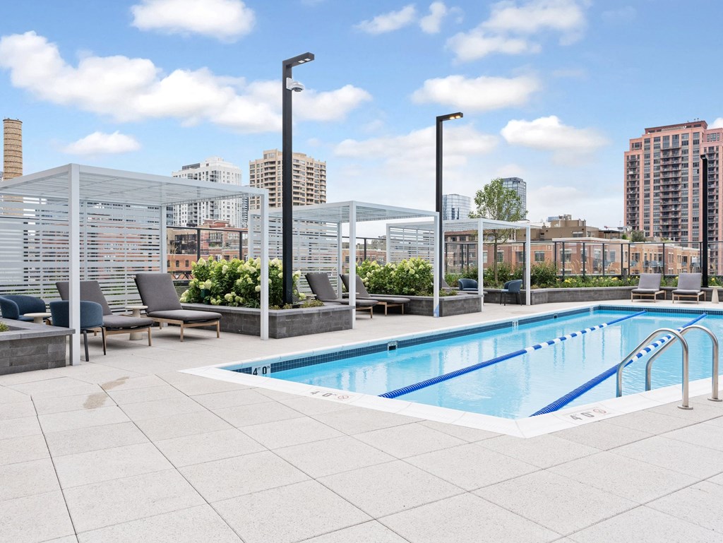 the pool on the rooftop of a building with a city in the background  at Cassidy on Canal, Chicago