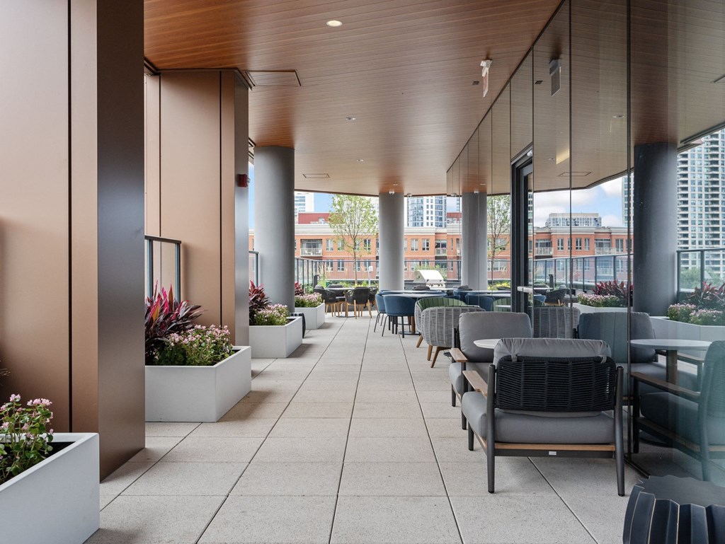 a large terrace with tables and chairs and a view of the city  at Cassidy on Canal, Chicago, Illinois