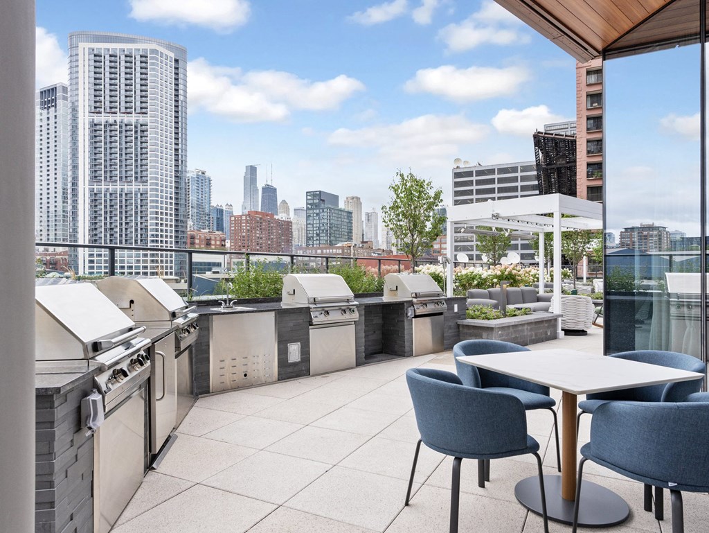 a rooftop patio with tables and chairs and a view of the city  at Cassidy on Canal, Illinois, 60606