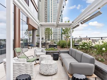 a living area with couches and chairs and a balcony with tall buildings  at Cassidy on Canal, Chicago, Illinois