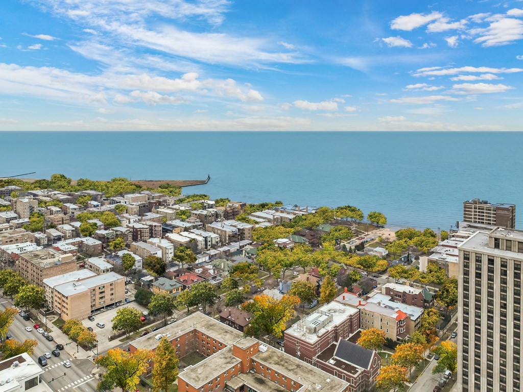 an aerial view of a city with the ocean in the background