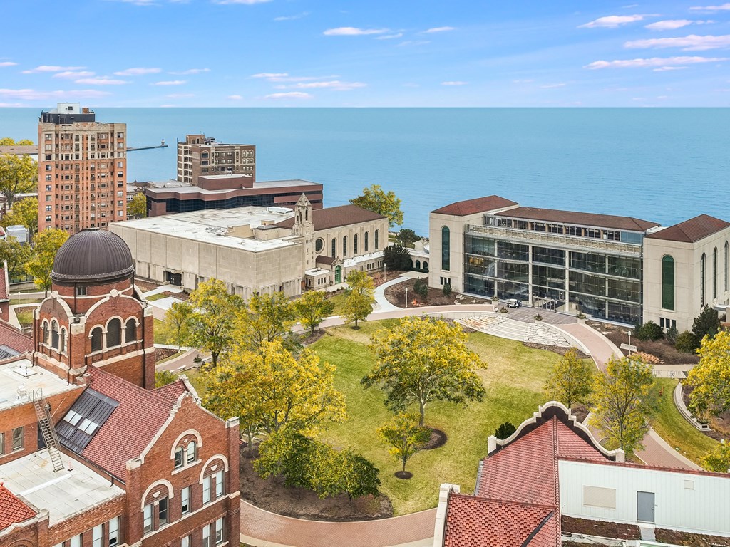 an aerial view campus with the ocean in the