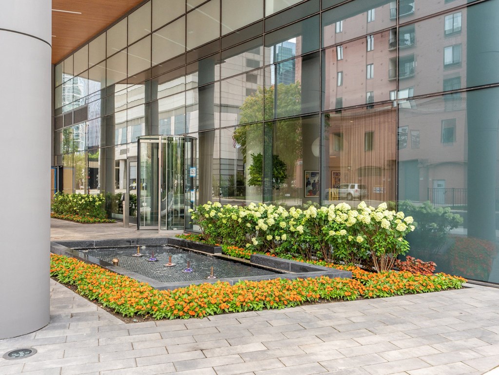 a courtyard with flowers in front of a glass building  at Cassidy on Canal, Illinois, 60606