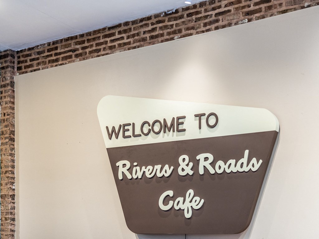 a sign that says welcome to rivers  roads cafe