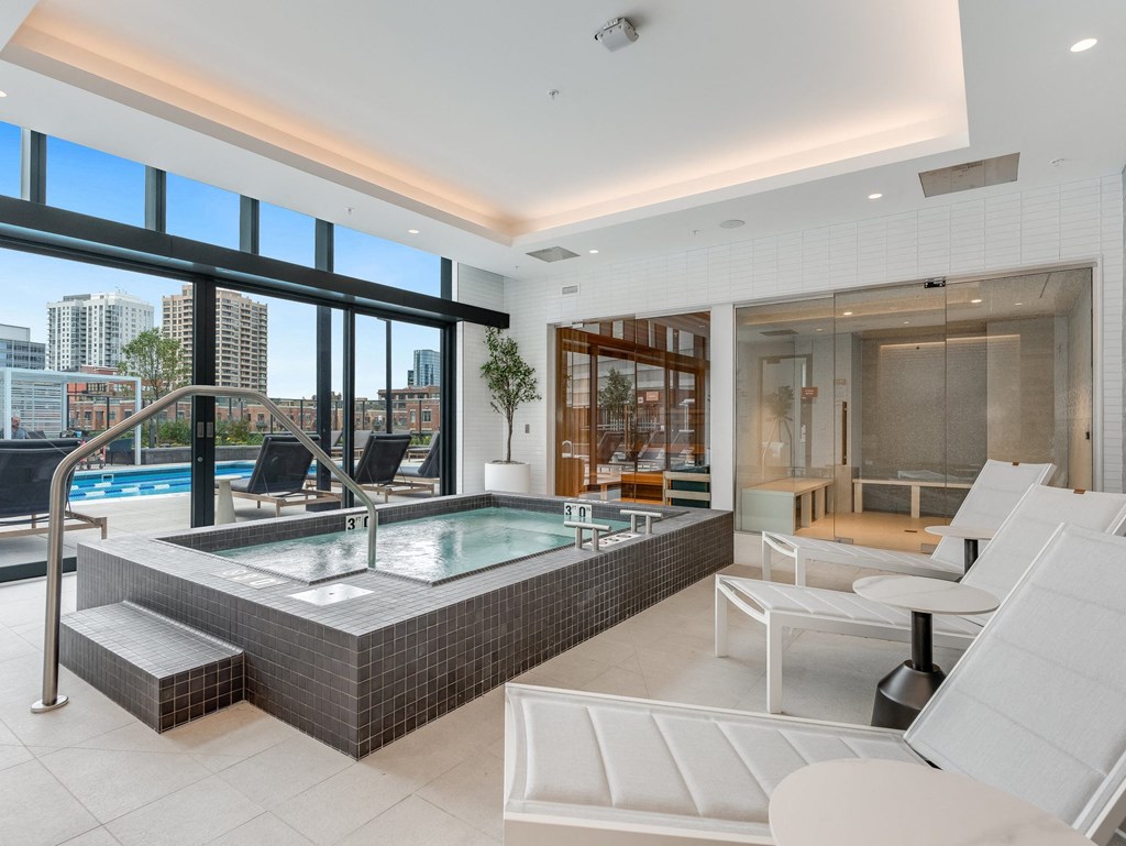 a spa area with a jacuzzi and a pool in a luxury apartment  at Cassidy on Canal, Chicago, 60606
