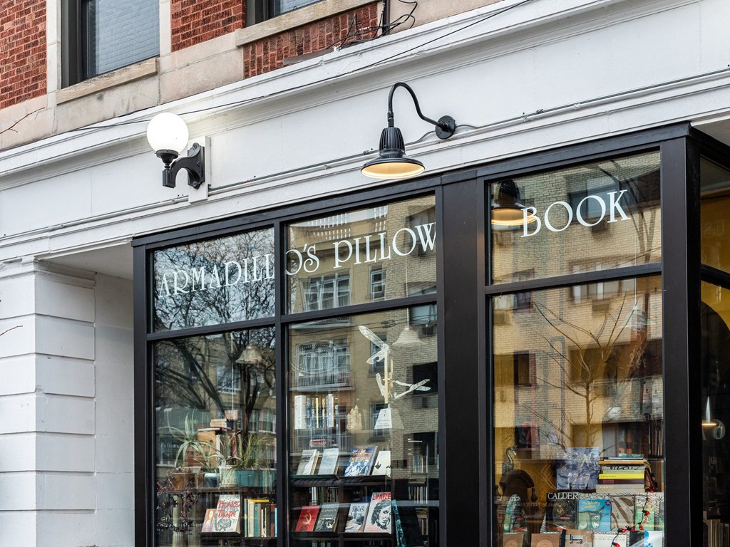 the front of a bookstore with books in the window