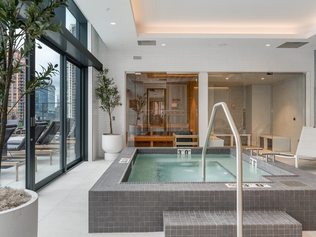 a large jacuzzi pool in the middle of a room with glass doors at Cassidy on Canal, Chicago