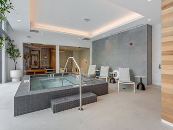 a spa with a jacuzzi and chairs in a room with a pool  at Cassidy on Canal, Chicago, IL, 60606